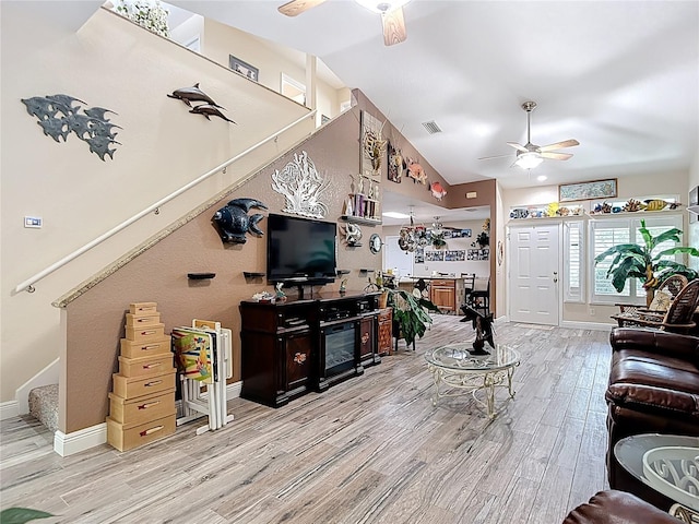 1628 Lullwater Ln, Lutz, FL 33549 - living room featuring ceiling fan, wood finished floors, stairs, baseboards, and high vaulted ceiling