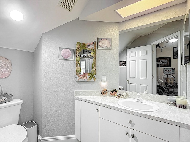 1628 Lullwater Ln, Lutz, FL 33549 - bathroom with a textured wall, lofted ceiling, toilet, vanity, and baseboards