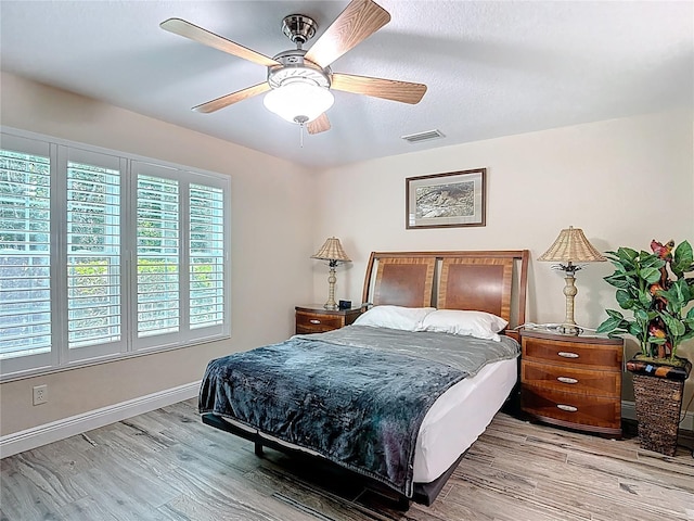 1628 Lullwater Ln, Lutz, FL 33549 - bedroom with wood finished floors, a ceiling fan, and baseboards