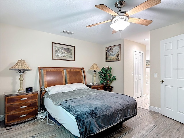 1628 Lullwater Ln, Lutz, FL 33549 - bedroom with wood finished floors, a textured ceiling, a ceiling fan, and baseboards