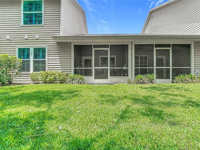 1628 Lullwater Ln, Lutz, FL 33549 - back of property with a lawn and a sunroom