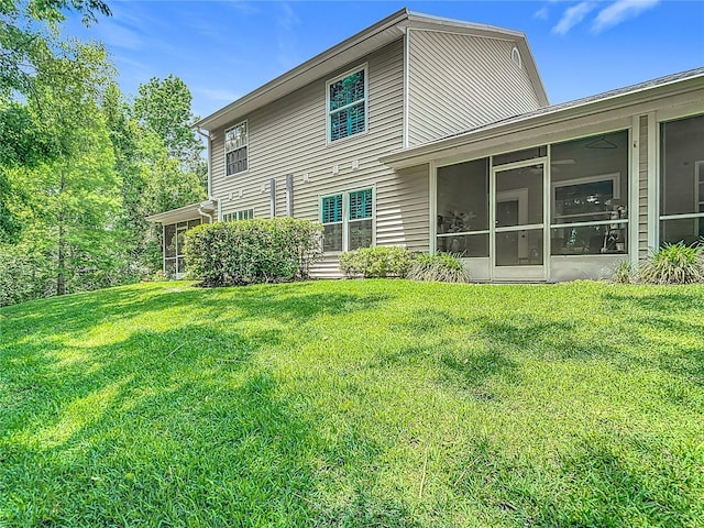 1628 Lullwater Ln, Lutz, FL 33549 - back of house featuring a sunroom and a yard