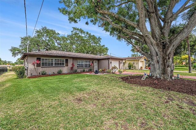 ranch-style house featuring an attached garage, stucco siding, concrete driveway, and brick siding