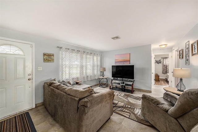 living room with light tile patterned flooring and baseboards