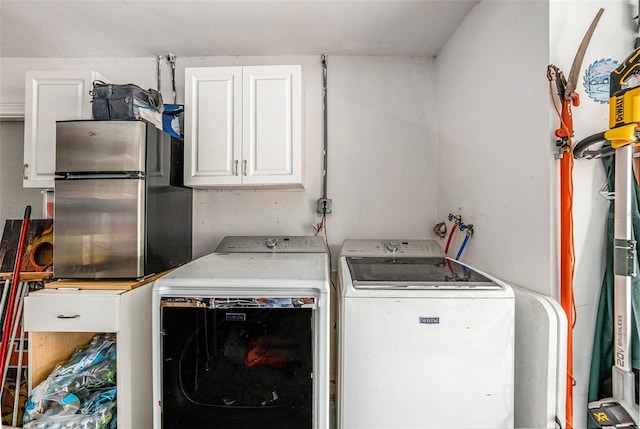 laundry area with cabinet space and washer and clothes dryer