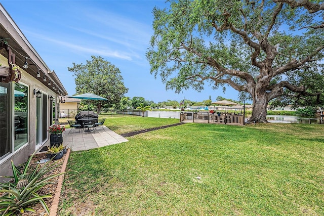 view of yard with a patio area and a water view