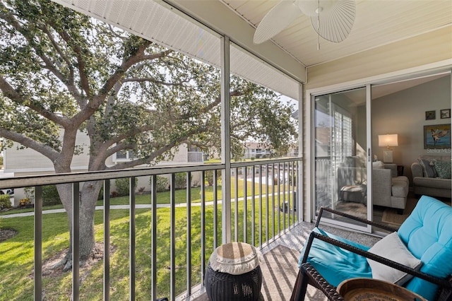sunroom featuring a ceiling fan