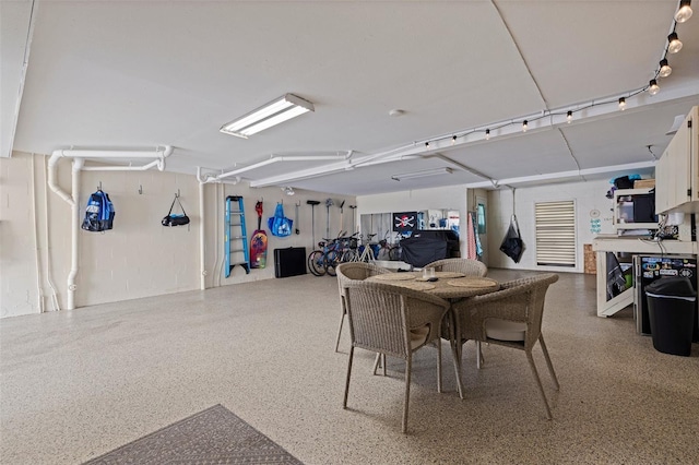 dining space featuring speckled floor