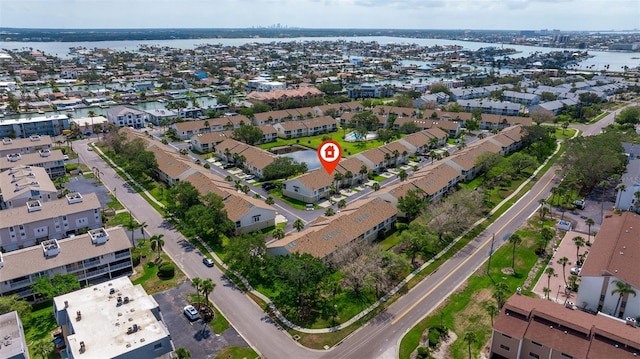 aerial view of property's location featuring a nearby body of water and nearby suburban area