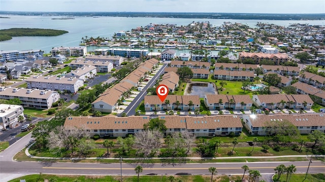 aerial view of property and surrounding area with a nearby body of water