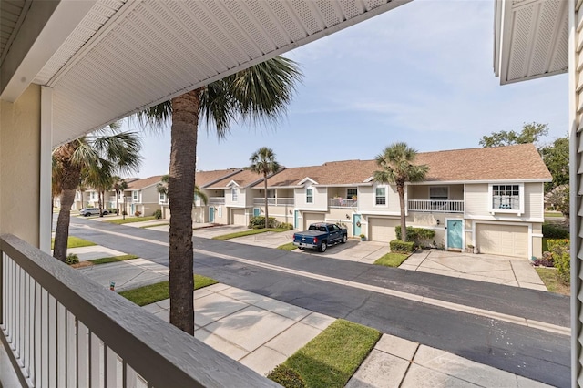 view of asphalt street with a residential view and sidewalks