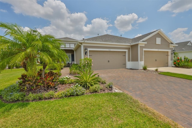 7406 Parkshore Dr, Apollo Beach, FL 33572 - view of front of property with decorative driveway, an attached garage, and a front lawn