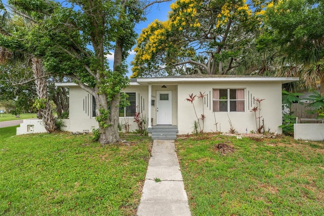 4600 Chancellor St NE, Saint Petersburg, FL 33703 - view of front of property with stucco siding and a front yard