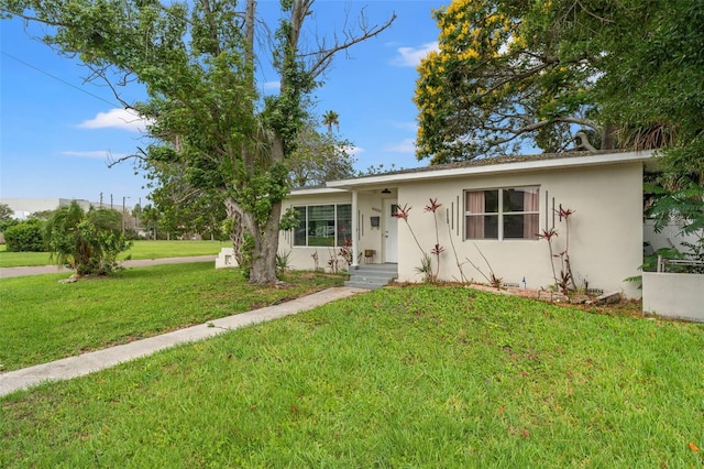 4600 Chancellor St NE, Saint Petersburg, FL 33703 - view of front of house featuring stucco siding and a front lawn