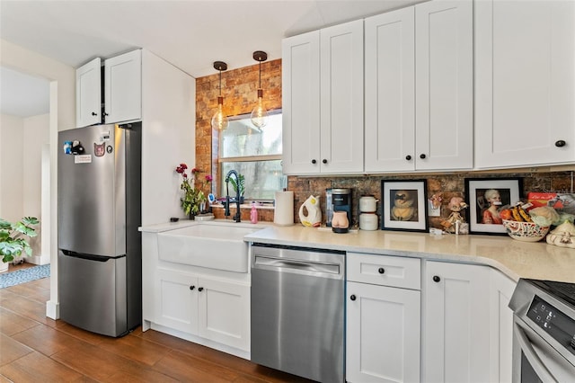 4600 Chancellor St NE, Saint Petersburg, FL 33703 - kitchen with appliances with stainless steel finishes, white cabinetry, and dark wood-style floors