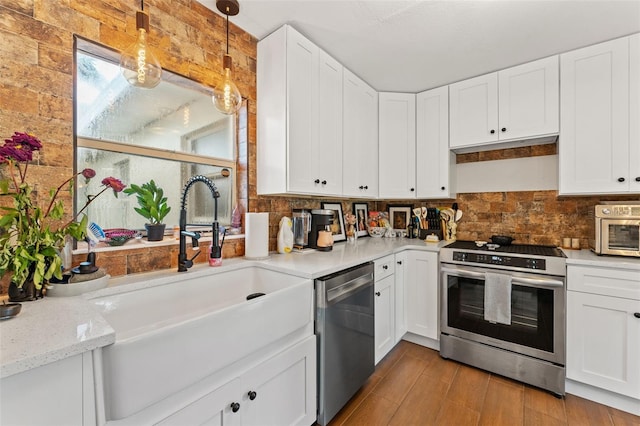 4600 Chancellor St NE, Saint Petersburg, FL 33703 - kitchen featuring stainless steel appliances, a sink, decorative backsplash, and white cabinets