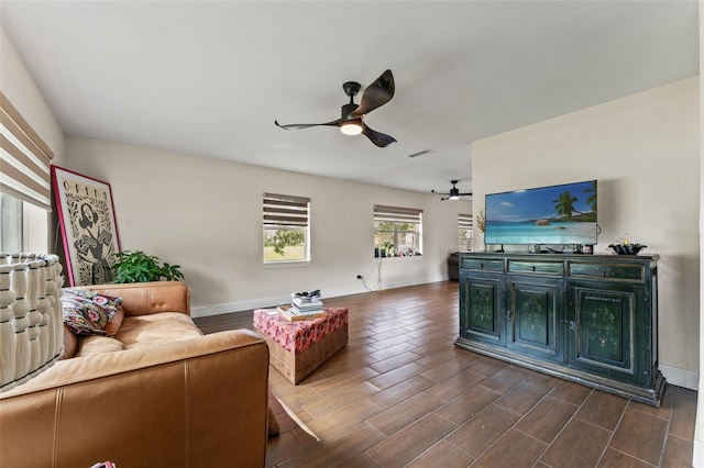4600 Chancellor St NE, Saint Petersburg, FL 33703 - living room featuring ceiling fan, baseboards, and dark wood-style floors