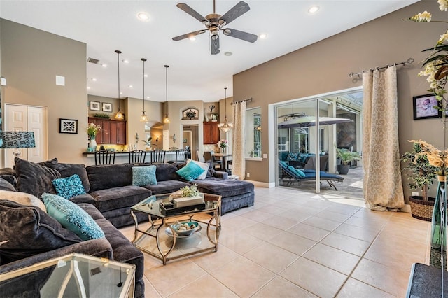 living area with a ceiling fan, light tile patterned flooring, and recessed lighting
