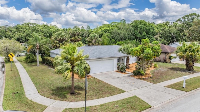 3230 Player Dr, New Port Richey, FL 34655 - view of front facade featuring a front lawn, driveway, an attached garage, and stucco siding