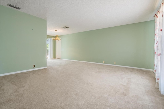 3230 Player Dr, New Port Richey, FL 34655 - empty room featuring a chandelier, carpet floors, baseboards, and a textured ceiling