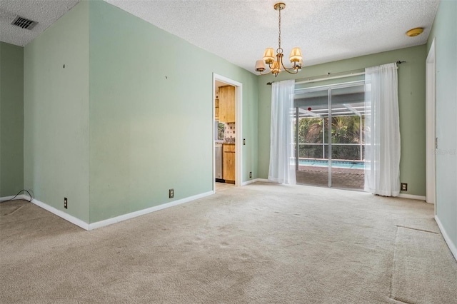 3230 Player Dr, New Port Richey, FL 34655 - spare room with carpet, a chandelier, a textured ceiling, and baseboards