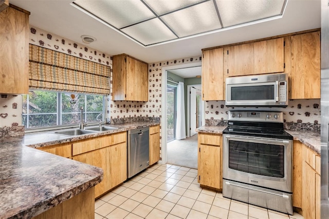 3230 Player Dr, New Port Richey, FL 34655 - kitchen featuring appliances with stainless steel finishes, a sink, light tile patterned floors, and decorative backsplash