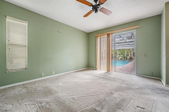 3230 Player Dr, New Port Richey, FL 34655 - spare room with a ceiling fan, carpet, baseboards, and a textured ceiling