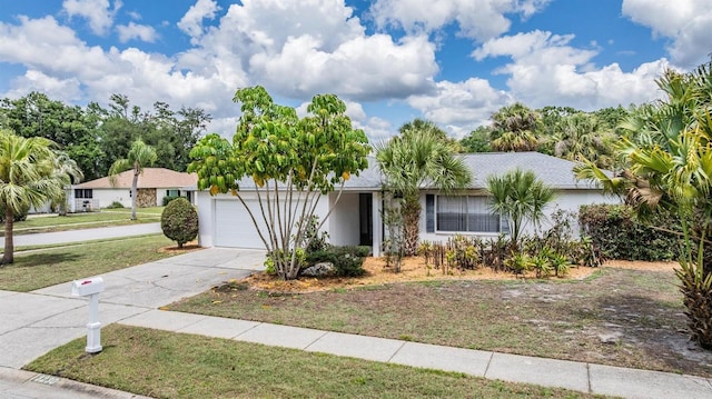 3230 Player Dr, New Port Richey, FL 34655 - view of front of property featuring an attached garage, concrete driveway, and a front yard