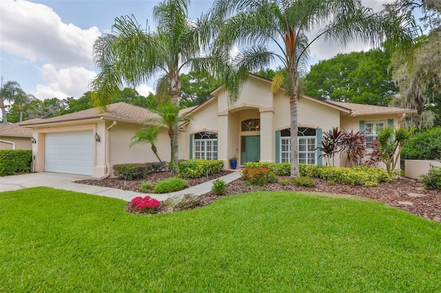 view of front of house with driveway, stucco siding, an attached garage, and a front lawn