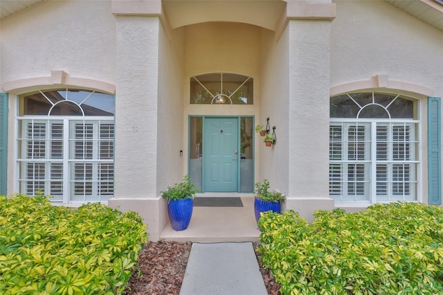 property entrance featuring stucco siding