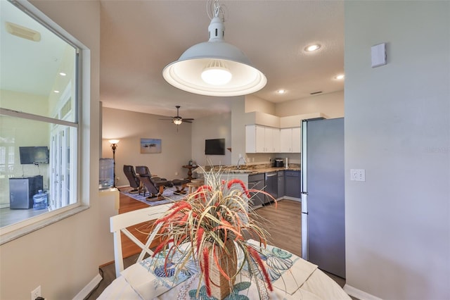 dining area featuring a ceiling fan, wood finished floors, baseboards, and recessed lighting