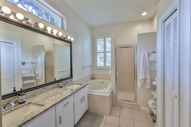 bathroom with a closet, tile patterned flooring, a whirlpool tub, and a shower stall