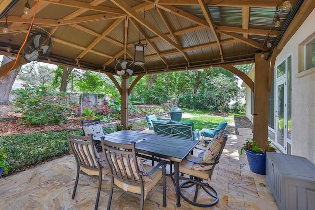 view of patio / terrace with outdoor dining area, french doors, a gazebo, and fence