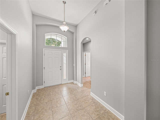 12713 Whitney Meadow Way, Riverview, FL 33578 - foyer with arched walkways, light tile patterned floors, and baseboards