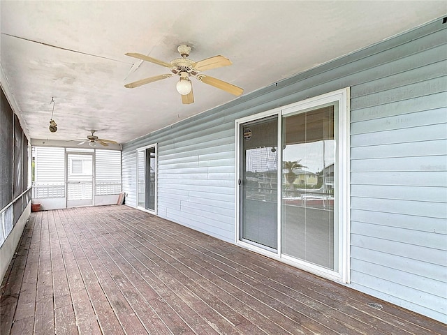 unfurnished sunroom featuring ceiling fan