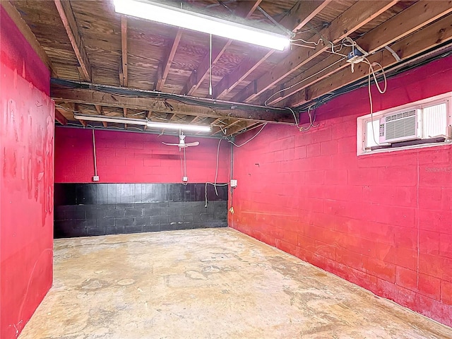 unfinished basement featuring concrete block wall