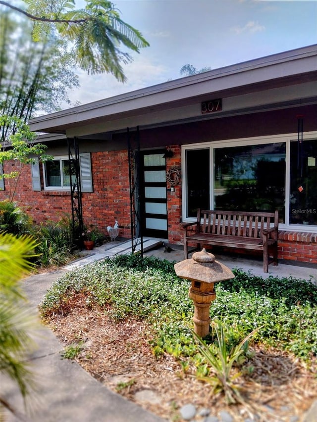 307 Druid Hills Rd, Temple Terrace, FL 33617 - view of front of home featuring brick siding and a porch