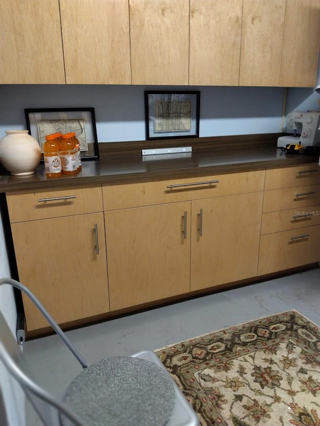 307 Druid Hills Rd, Temple Terrace, FL 33617 - kitchen with light brown cabinetry, dark countertops, and marble look tiles