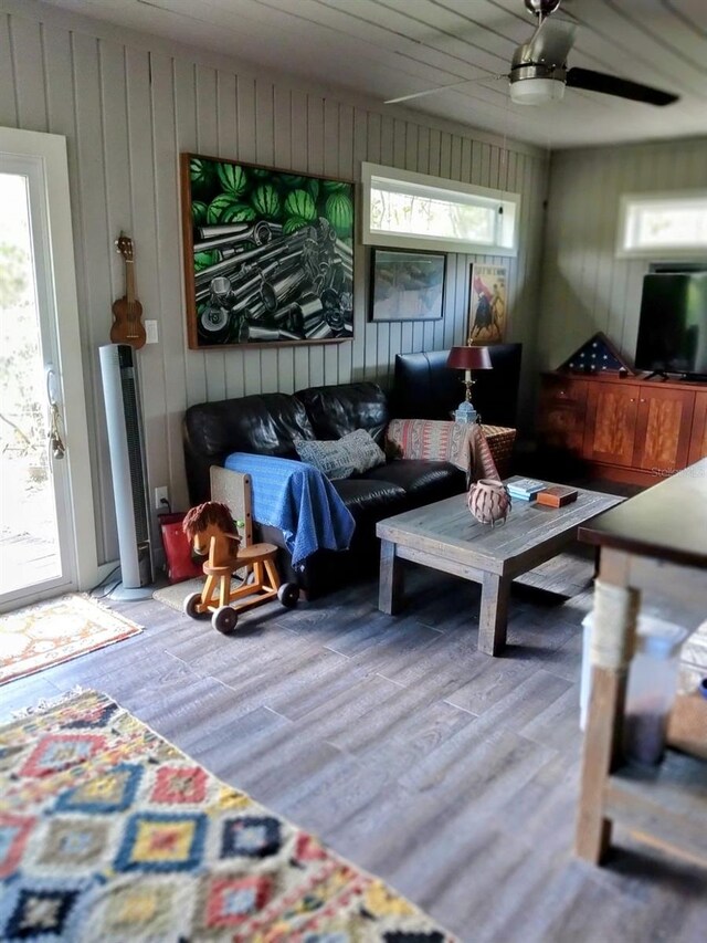307 Druid Hills Rd, Temple Terrace, FL 33617 - living area with healthy amount of natural light, wood finished floors, wood walls, and a ceiling fan