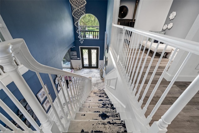 19620 Eagle Crest Dr, Lutz, FL 33549 - staircase with a towering ceiling, french doors, and wood finished floors