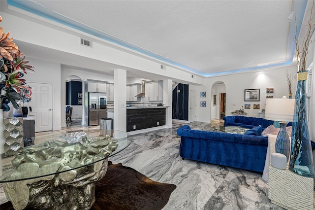 19620 Eagle Crest Dr, Lutz, FL 33549 - living room featuring arched walkways and light marble finish floors
