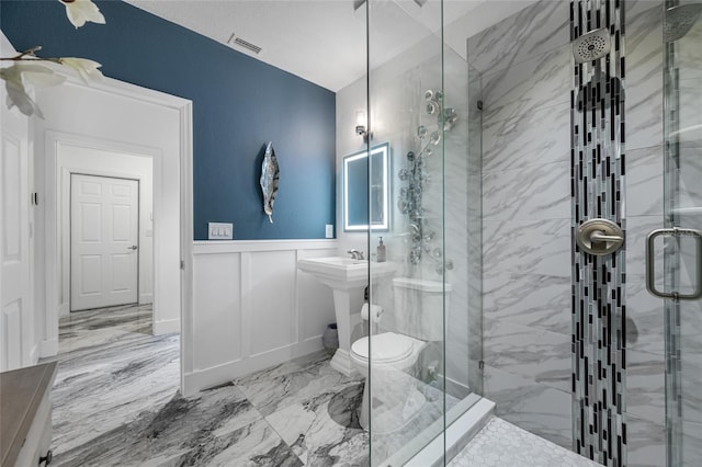 19620 Eagle Crest Dr, Lutz, FL 33549 - bathroom with a stall shower, marble finish flooring, a wainscoted wall, toilet, and a decorative wall
