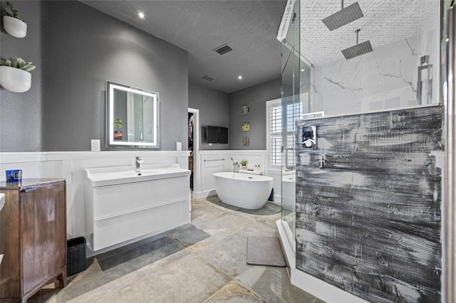 19620 Eagle Crest Dr, Lutz, FL 33549 - bathroom featuring a stall shower, a freestanding tub, vanity, and wainscoting