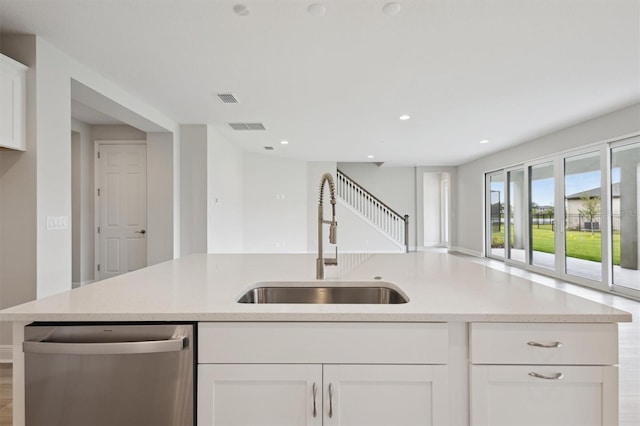 13137 Wellspring Dr, Lithia, FL 33547 - kitchen with stainless steel dishwasher, white cabinetry, recessed lighting, and open floor plan