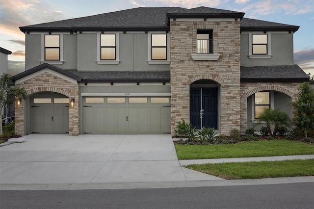 13137 Wellspring Dr, Lithia, FL 33547 - view of front of house featuring stone siding, a shingled roof, stucco siding, and concrete driveway