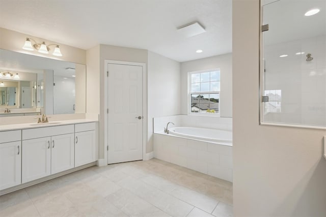 13137 Wellspring Dr, Lithia, FL 33547 - full bathroom featuring vanity, a garden tub, a tile shower, tile patterned floors, and recessed lighting