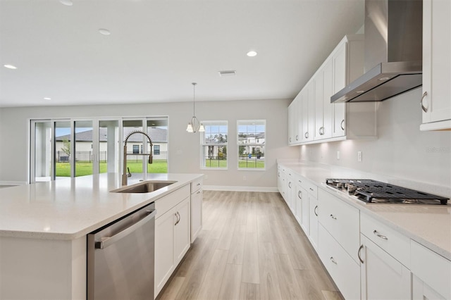 13137 Wellspring Dr, Lithia, FL 33547 - kitchen with wall chimney exhaust hood, appliances with stainless steel finishes, light wood-style flooring, healthy amount of natural light, and recessed lighting
