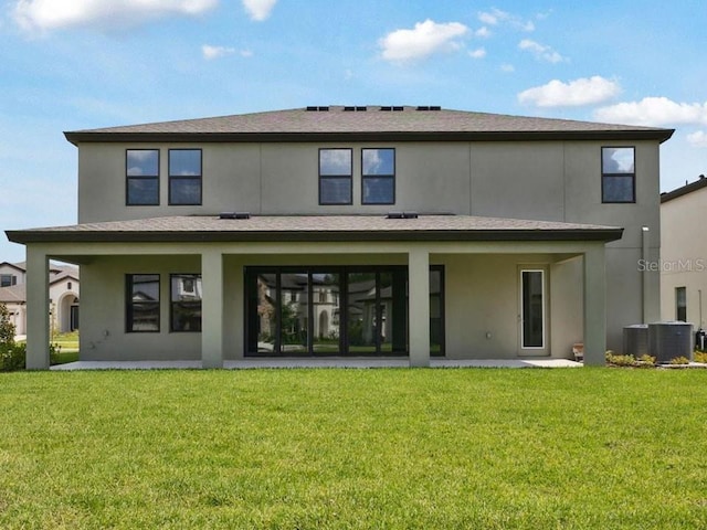 13137 Wellspring Dr, Lithia, FL 33547 - rear view of house with stucco siding and a yard