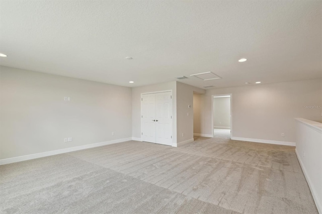 13137 Wellspring Dr, Lithia, FL 33547 - empty room with recessed lighting, attic access, and light colored carpet