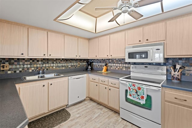 13440 Gulf Blvd Unit 501, Madeira Beach, FL 33708 - kitchen featuring white appliances, light brown cabinets, a sink, backsplash, and light wood-type flooring